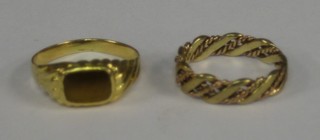 A lady's modern 18ct gold signet ring and an Oriental gold ring