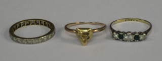 A gold dress ring in the form of a foxes mask, an eternity ring and 1 other dress ring set green and white stones