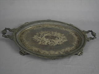 An oval silver plated twin handled tea tray, raised on panel supports 27"