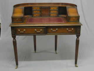 A 20th Century Carlton House writing table with raised back fitted a cupboard and 6 short drawers, the base fitted 2 drawers, raised on turned and fluted supports 42"