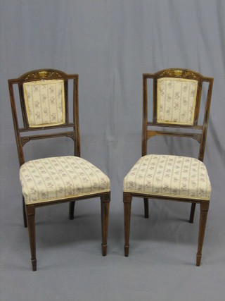 A pair of Edwardian inlaid rosewood bedroom chairs raised on square tapering supports ending in spade feet by Thomas Turner of Manchester