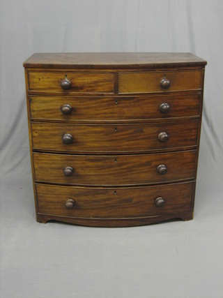 A Georgian mahogany bow front chest of 2 short and 4 long drawers with tore handles, raised on bracket feet 41"