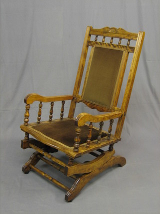 A 19th Century mahogany American rocking chair with bobbin turned decoration