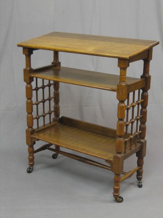 A Victorian oak aesthetic movement honey oak bookcase with reading slope, bobbin turned decoration to the side and raised on turned and block supports 27"