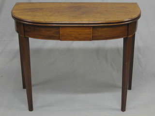 A Georgian mahogany demi-lune card table with satinwood inlay, raised on square tapering supports 36"
