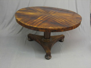 A William IV Rosewood circular snap top breakfast table the top with sunburst inlay raised on a chamfered column with triform base and bun feet, 48" (crack to top)