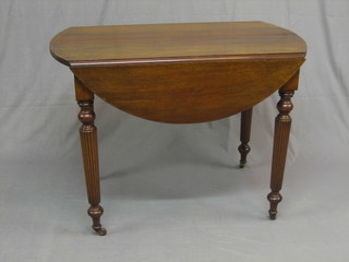 A 19th Century oval Continental mahogany drop flap extending dining table, raised on turned and reeded supports with 2 extra leaves 39" 