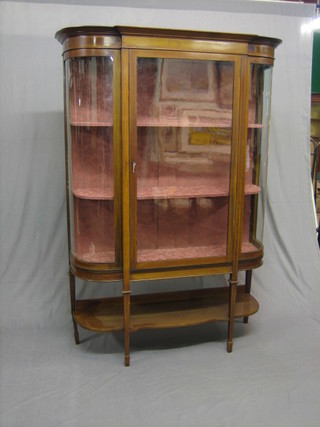 An Edwardian inlaid mahogany D shaped display cabinet, the interior fitted shelves enclosed by glazed panelled doors, raised on square tapering supports ending in spade feet with undertier (1 back leg f and r) 56"