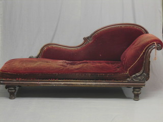 A Victorian carved mahogany show frame chaise longue upholstered in red material 74"