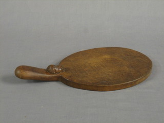 An oak oval Mouseman cheese board, the handle decorated a mouse 14 1/2"
