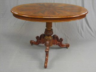 A 19th Century oval flame mahogany occasional table, raised on a carved column with tripod supports 42"