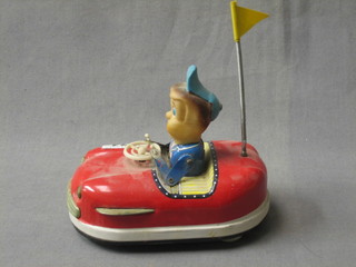 A Japanese tin plate clock work model of a bumper car with driver