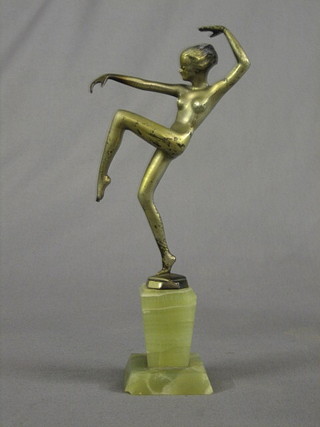 An Art Deco silvered figure of a standing dancing naked girl, raised on a green marble base 8" (chip to base)