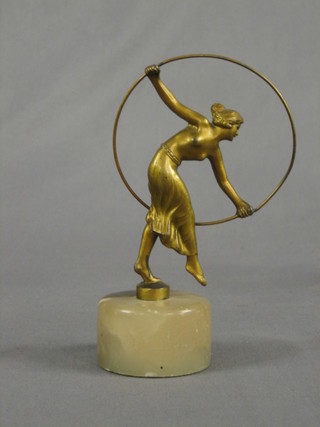 An Art Deco gilt painted spelter figure of a standing semi-naked girl with hoop, raised on a circular marble base 5 1/2" (hoop f and r)