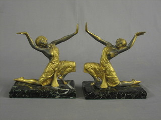 A pair of Art Deco gilt painted spelter figures of kneeling dancing ladies, raised on black veined marble bases 7"