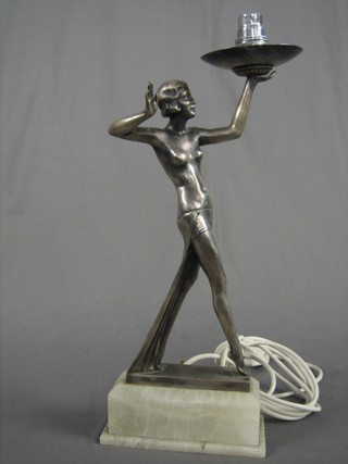 An Art Deco style silvered spelter table lamp in the form of a walking lady raised on a white onyx base 16"