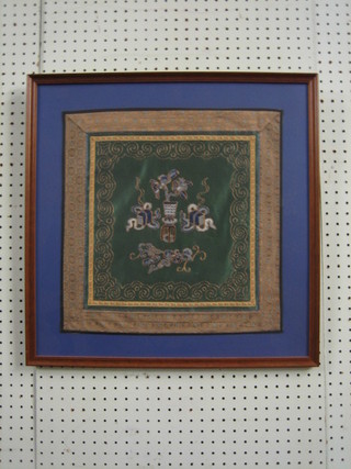A green ground Chinese embroidered panel depicting a vase 15" x 15"