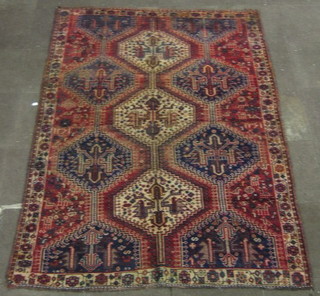 A contemporary Qashqai rug with all over geometric design to the centre 97" x 66"