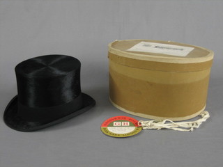 A gentleman's black silk top hat by Henry Heath, approx size 7, contained in a paper box