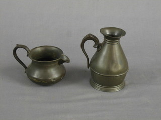 A Victorian baluster pewter jug with scrolled handle, the base marked Austin & Son, 5" together with a circular pewter cream jug, the base with crowned Tudor rose, some old repair to body