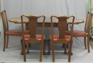 An Edwardian Georgian style dining suite comprising oval extending dining table, raised on cabriole supports together with 4 splat back dining chairs with upholstered drop in seats, raised on cabriole ball and claw supports