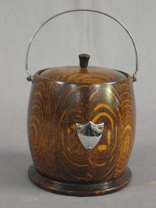 A turned oak biscuit barrel