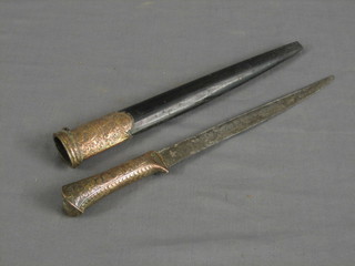 An Eastern dagger with 9" straight blade contained in an ebony and engraved copper scabbard