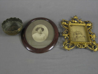 A pierced gilt metal photograph frame 10" x 8", an oval black and white photograph of a lady in a wooden frame and a circular Benares brass bowl 5"