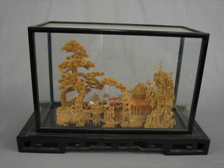 A cork sculpture of an Oriental building with trees 17" contained in a glazed display case