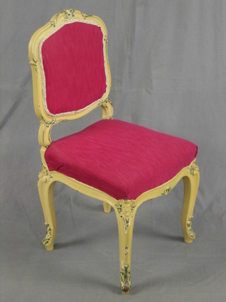 A 19th Century French white painted salon chair upholstered in pink, raised on cabriole supports