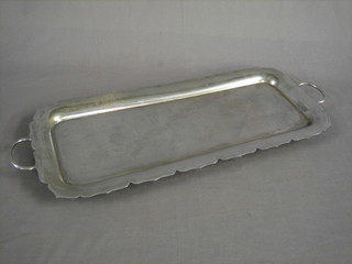 A rectangular chromium plated twin handled bottle tray raised on bun feet 24"