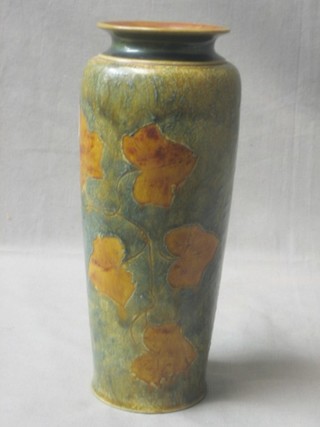 A cylindrical Royal Doulton vase with Autumnal leaf decoration the base marked Royal Doulton 85 31 D 10"