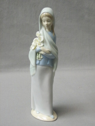 A Lladro figure of a standing girl with Lilies, base impressed 2, 9"