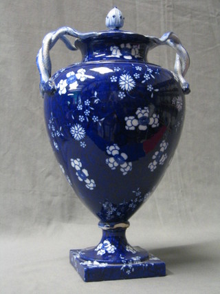 A 19th Century Copeland Flo Blue pattern porcelain urn and cover with twin serpent handles (heavily f and r) 15"