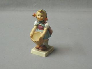 A Goebal figure of a standing girl with basket - Little Helper, 4"
