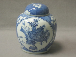 An 18th/19th Century Oriental blue and white ginger jar and cover with panel decoration depicting a vase of flowers, the base with 4 character mark, 5"