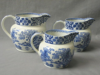 A set of 3 Malingware blue and white graduated pottery jugs