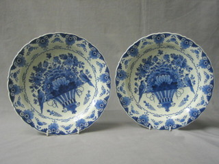 A pair of 20th Century Delft pottery plates decorated baskets of fruit, the reverse marked A J 76, 11"