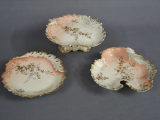 A 20 piece Limoges porcelain dessert service comprising 2 circular comports 9", 3 shaped dishes (1 cracked 1 chipped) 10", 15 circular plates 9 1/2" (4 chipped), some rubbing to the gilding