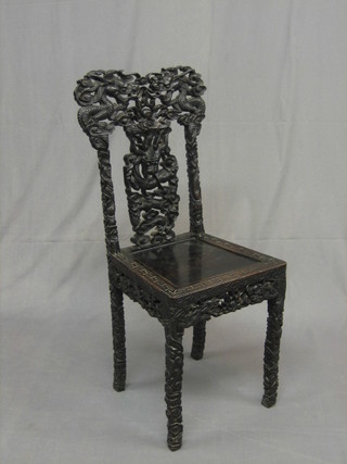 A 19th Century Eastern pierced and carved hardwood splat back chair