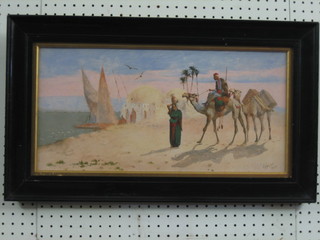 J Coulson, Egyptian School oil on board "The Oasis, Figures with Camels" 10" x 20", contained in a wooden