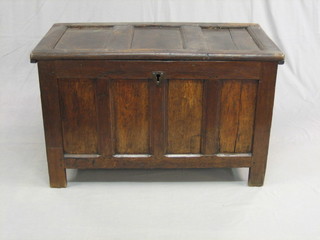 A 17th/18th Century coffer of panelled construction with hinged lid the interior fitted a candle box, 39"