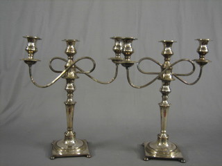 A handsome pair of silver plated 3 light candelabrum raised on square bases with bun feet 18"