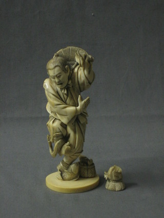 A fine quality 19th Century Japanese carved ivory figure of a standing fisherman being bitten by a snake holding a basket above his head (f), signed to the base 6"