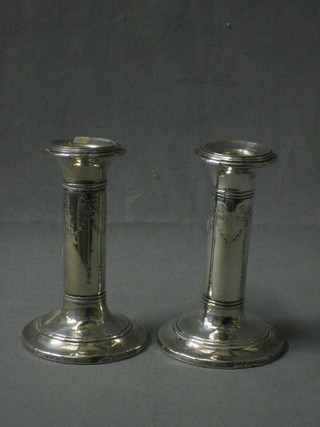 A pair of Edwardian silver candlesticks with embossed swag decoration Birmingham 1909 5"