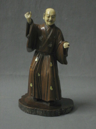 A 19th Century ivory and Fujiama figure of a standing sage, raised on a wooden base 7" (1 hand f)