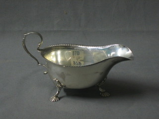 A Georgian style  silver sauce boat with embossed wavy border, raised on 3 feet with Jubilee hall mark, Birmingham 1935 3 ozs