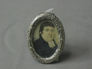A 19th Century portrait miniature on ivory of a parson, contained in an Edwardian oval embossed silver easel photograph frame, Birmingham 1900, 3"
