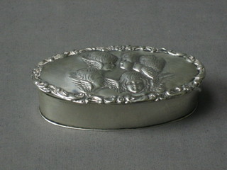An Edwardian oval silver trinket box the lid decorated angels Birmingham 1903, 4"