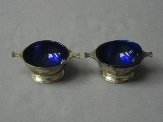 A pair of Edwardian silver quaiche shaped salts with blue glass liners, London 1909 3 ozs